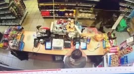 Brave cashier defends herself from robber armed with broken bottle