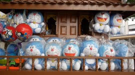 Superstitious locals offer 'Doraemon' cartoon toys for good luck at shrine in Bangkok, Thailand