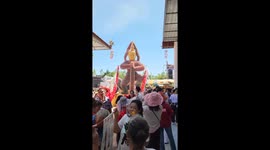 Giant Thai mythology god covered in banknotes parades streets