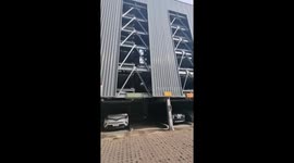 Automatic parking lift collapses leaving car hanging precariously from beams