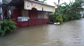 Heavy rain floods the streets of Bulan in the Philippines