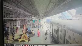 Indian man lucky to escape tragedy after nearly being pulled under moving train while trying to jump on