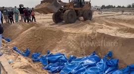 Gaza war: Bulldozer covers bodies with sand in mass grave in Khan Yunis