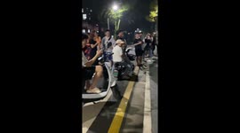 Me-row! Tabby cat and white cat argue in street as locals watch