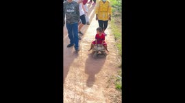 Toddler rides pet tortoise like a horse