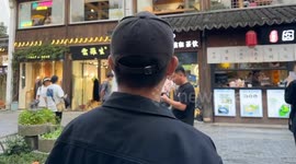 Tourist imitates dog barking sounds outside Chinese pet cafe