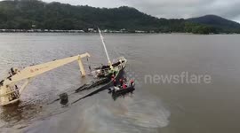 Philippine Coast Guard place oil spill booms around submerged Vietnamese ship