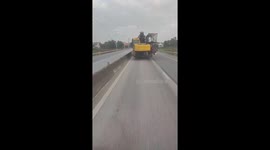 The truck carrying 2 excavators and many goods exceeding its load moved at high speed
