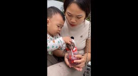 Adorable Pika: one-year-old monkey sips smoothie from cup in Hai Phong, Vietnam