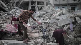 A Palestinian citizen in Gaza searches for the remains of his family who were bombed by Israeli aircraft