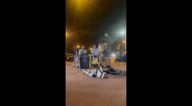 French Bulldog lies on his back listening to buskers
