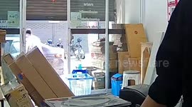 Distracted shop owner hits head on low-lying roll-up door