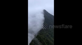 China: Spectacular Footage Of Rain Clouds Intercepted By Mountain Peaks On Yunnan Plateau