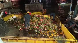 Cleaners clear waterways blocked by floral baskets from Buddhist festival