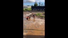 Boy Plays in Mud Puddle