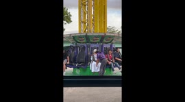 Catholic nun looks delighted on extreme theme park ride