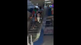 Shoppers walk the wrong way up escalator in the Philippines