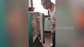 Residents use elastic rubber strap to fix broken fridge door