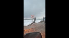 Risky storm video: woman braves winds for footage
