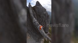 Climber makes nail-biting 2,019m ascent on limestone ridge - no wider than his SHOULDERS