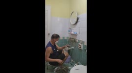 Bathroom wall falls onto man while he repairs tiles