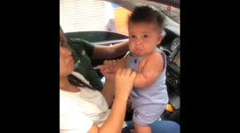 Silly baby boy humors his family by rapidly switching between sad & happy faces