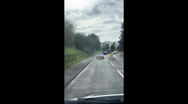 VIDEO: Pair have lucky escape after car caught fire as they were driving along road