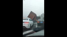 Truck blown over by strong wind on highway in China