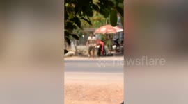 Residents spray fire suppresant on burning motorcycle