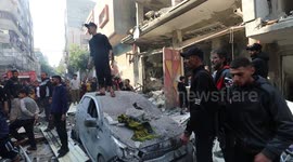 Palestinian search and rescue team and civilians gather to conduct search and rescue operation among rubble of buildings following the end of the week-long 'humanitarian pause' after Israeli attacks on Al-Maghazi refugee camp