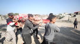 Palestinian search and rescue team and civilians gather to conduct search and rescue operation among rubble of buildings