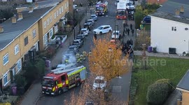 The London Fire Brigade working together to extinguish a burning car