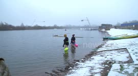 Swimmers brave the cold as they plunge into an icy lake in Derbyshire, UK