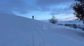 Skier Skiing on Kendal Fell from the deluge of snow that fell in Kendal on 2nd December and Lake District