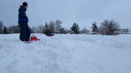 A family enjoying some sledging time after a deluge of snow brought chaos to Kendal and the Lake District