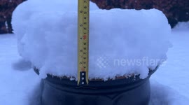 Snow depth in Kendal, Cumbria. A measurement of snow on top of a plant pot