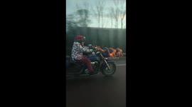 Santa's upgraded his ride: Motorcyclist cruises along highway on festive bike