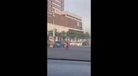 Traffic enforcer dressed as Santa Claus directs cars