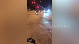 Snake weaves around cars at busy junction in Thailand