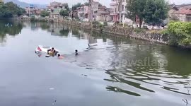 Brave Chinese villagers save mother and children from drowning after car plunges into river