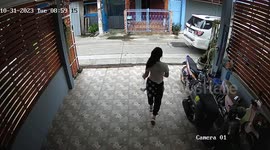 Sliding driveway gate topples over as woman closes it