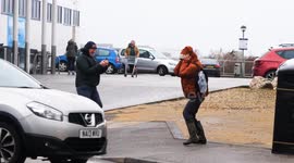 UK Weather, Shoppers fight the gale force winds in Newquay Cornwall UK