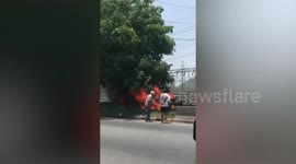 Motorists rush to extinguish flames engulfing pickup truck on Thai highway