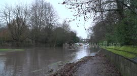 Cars left abandoned on flooded road after melted snow and heavy snow cause widespread flooding, Derbyshire, UK