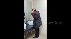 Chinese man spotted styling hair with lighter in public restroom