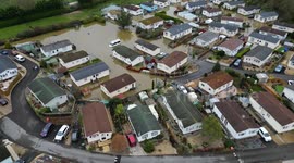 Emergency evacuation of caravan park underway after major flooding ruins homes and vehicles