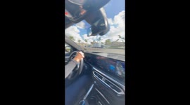 Passenger films as he driven around San Diego course by racing legend