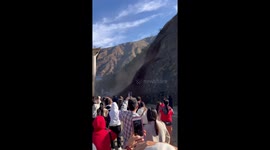 Visitors watch spectacular landslide across mountain road