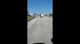 Lorry door swings open on motorway in Thailand