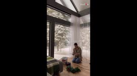 Woman makes a Christmas Wreath to hang on her house's front door